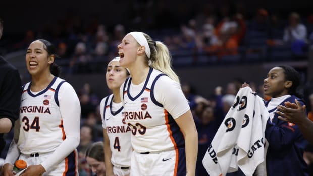 Sam Brunelle celebrates on the bench during the Virginia women's basketball game against Notre Dame at John Paul Jones Arena.